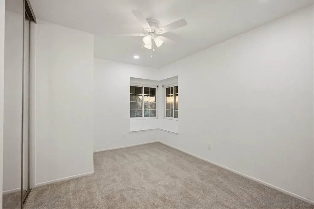 39900 Quigley Road Murrieta, CA 92562 - Photo 54 of 58 an empty room with windows and ceiling fan