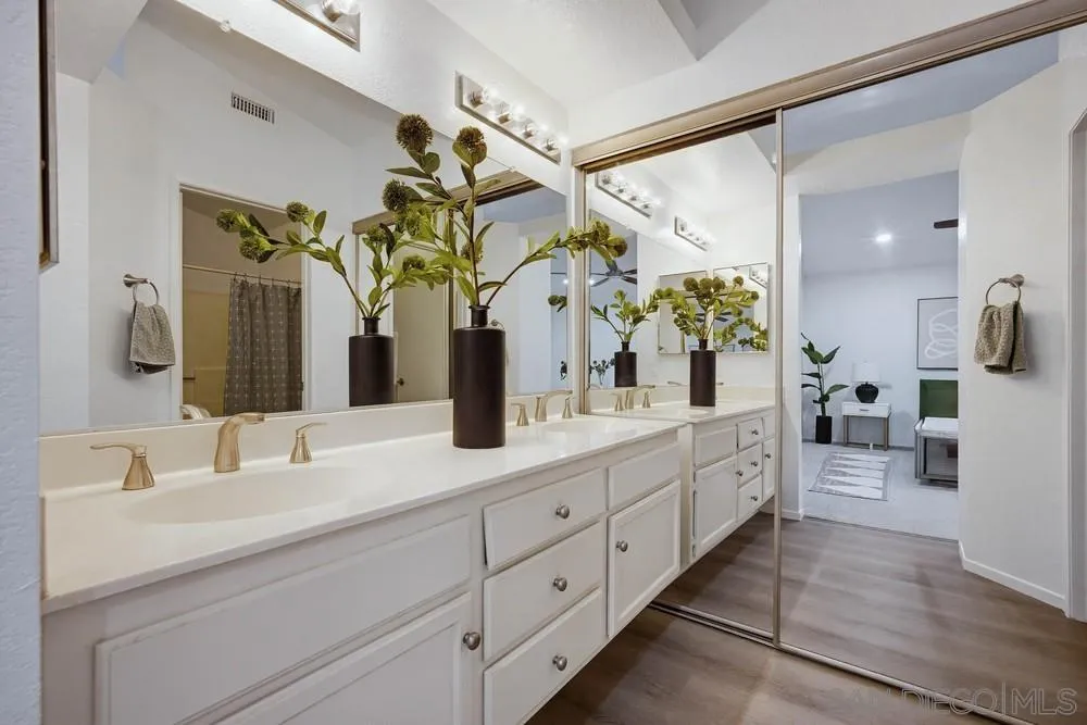 39900 Quigley Road Murrieta, CA 92562 - Photo 55 of 58 a bathroom with a granite countertop sink a potted plant and a mirror