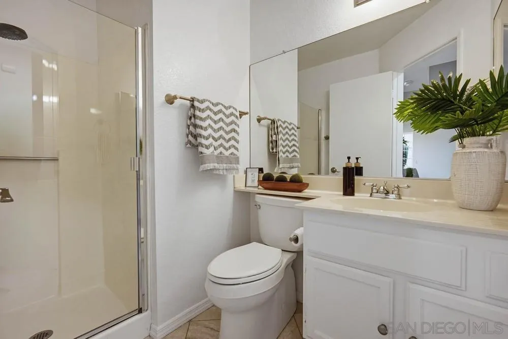 39900 Quigley Road Murrieta, CA 92562 - Photo 58 of 58 a bathroom with a toilet a sink and mirror