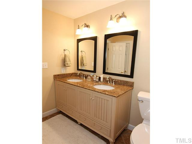 1928 Wilton Circle Raleigh, NC 27615 - Photo 11 of 17 Remodeled master bath with new granite counter top , cabinetry, mirror, lights, toilets, tile floors and paint! do not miss the beautiful custom tiled shower too! Other