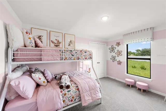 a bed sitting in a bedroom next to a window