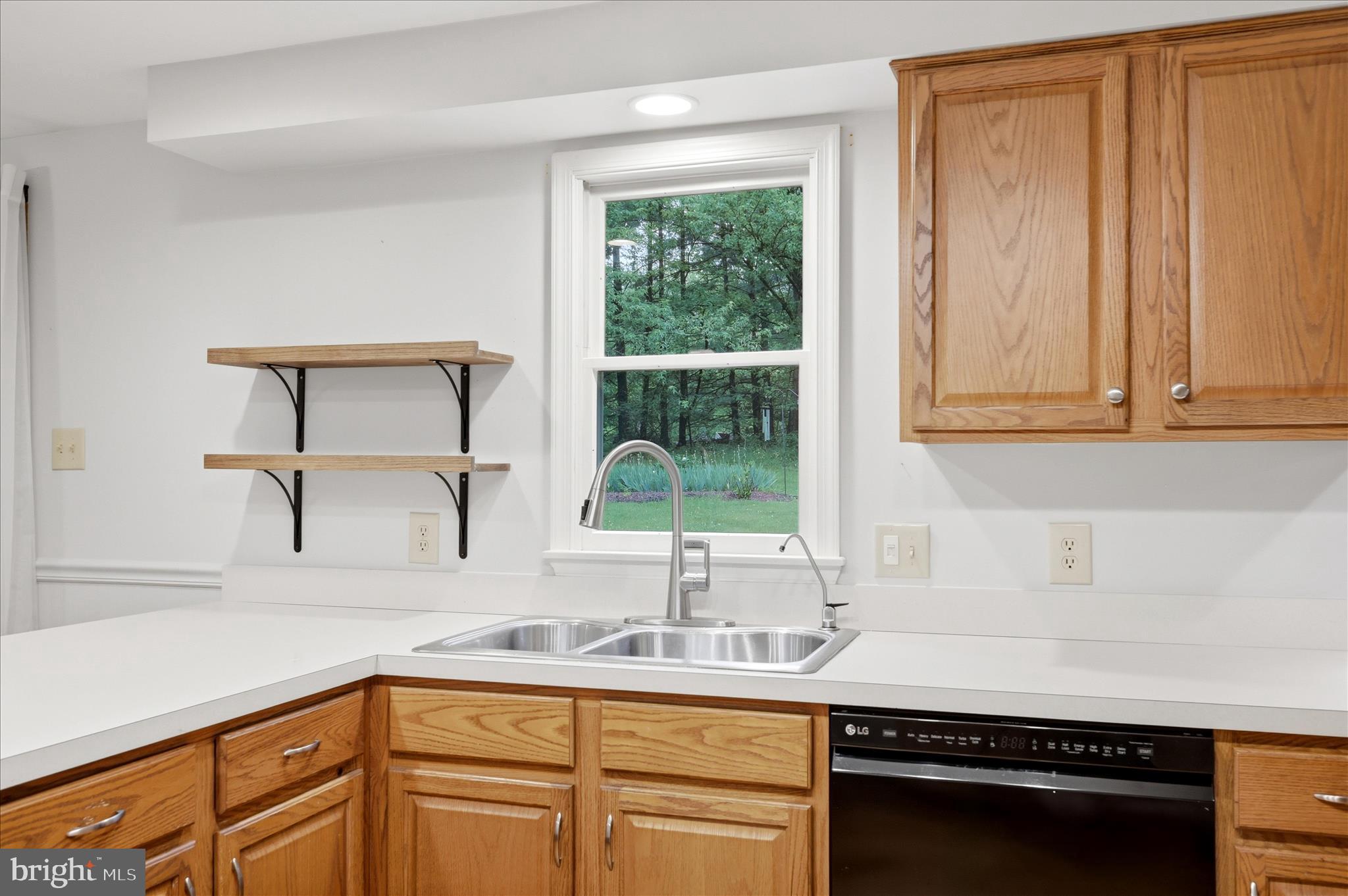244 High Banks Road Stephenson, VA 22656 - Photo 18 of 45 a kitchen with stainless steel appliances granite countertop a sink a stove cabinets and a window