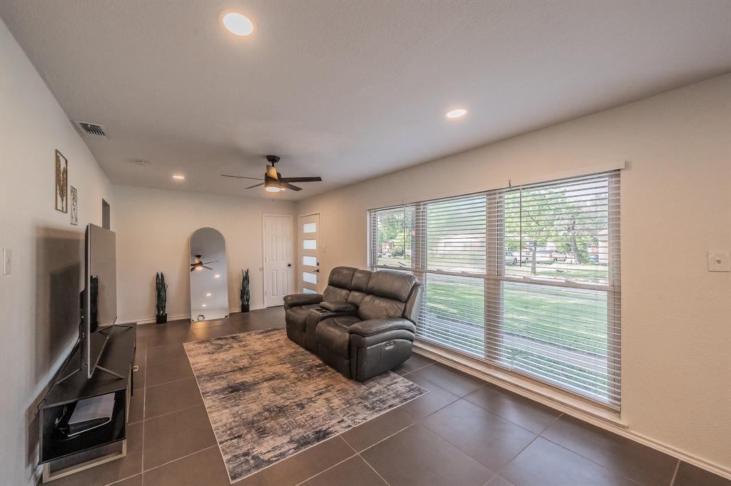10866 Cassandra Way Dallas, TX 75228 - Photo 6 of 22 a living room with furniture fireplace and a large window