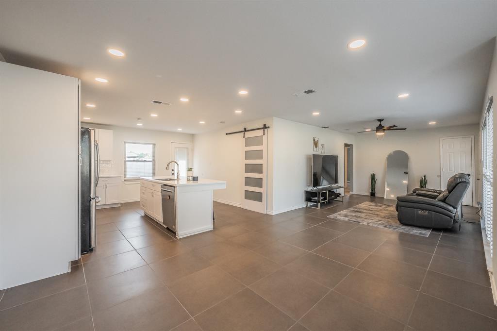 10866 Cassandra Way Dallas, TX 75228 - Photo 7 of 22 a large room with gym equipment and a view of living room