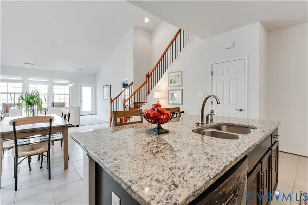 a kitchen with granite countertop sink and cabinets