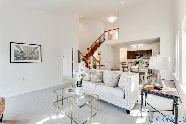 a living room with furniture and kitchen view