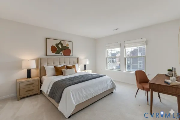 a bedroom with a bed and a large window