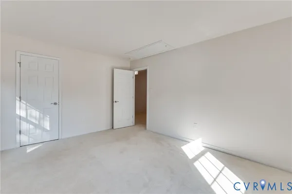 a view of an empty room and a window