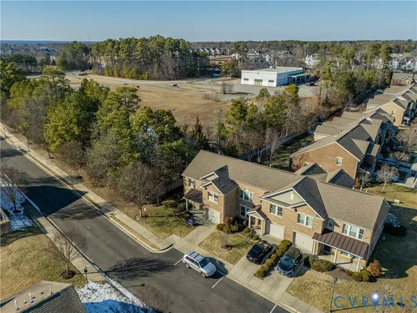 an aerial view of a house with a yard basket ball court and outdoor seating