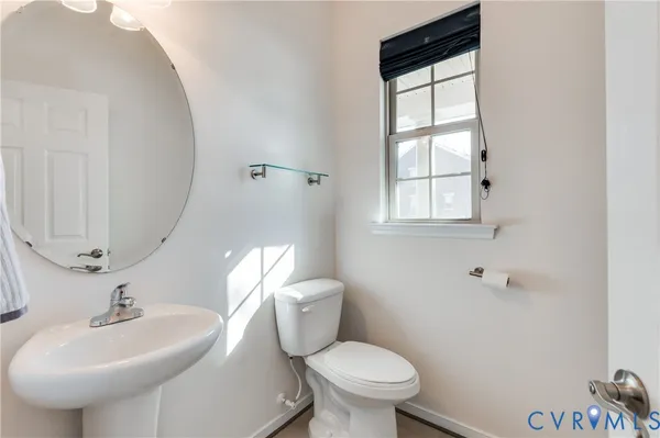 a bathroom with a sink toilet and mirror
