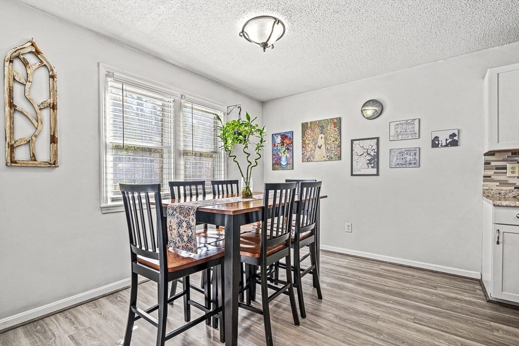 124 Tennis Plaza Road, Unit 21 Dracut, MA 01826 - Photo 12 of 27 a view of a dining room with furniture window and wooden floor