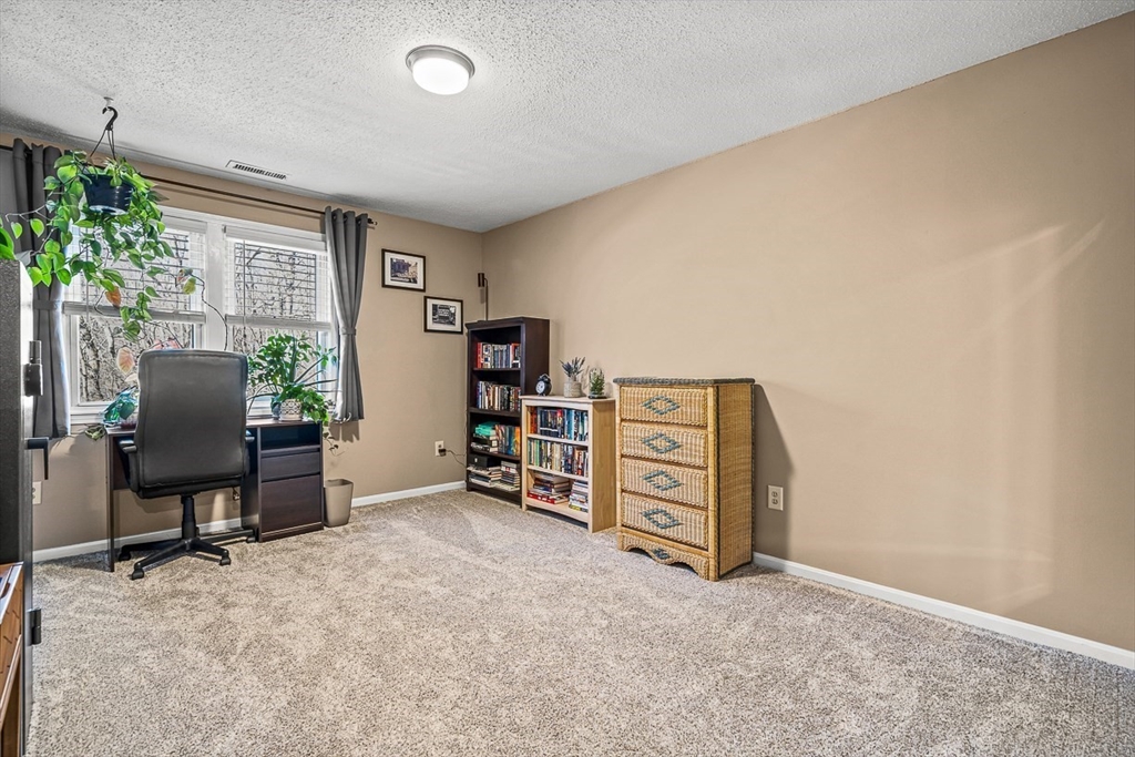 124 Tennis Plaza Road, Unit 21 Dracut, MA 01826 - Photo 16 of 27 an empty room with furniture and a window