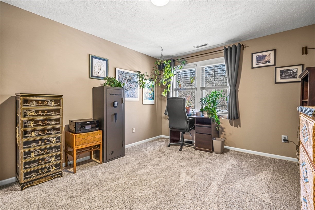 124 Tennis Plaza Road, Unit 21 Dracut, MA 01826 - Photo 17 of 27 a view of a workspace with furniture and a window