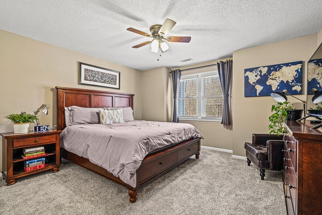 124 Tennis Plaza Road, Unit 21 Dracut, MA 01826 - Photo 19 of 27 a spacious bedroom with a bed and a window