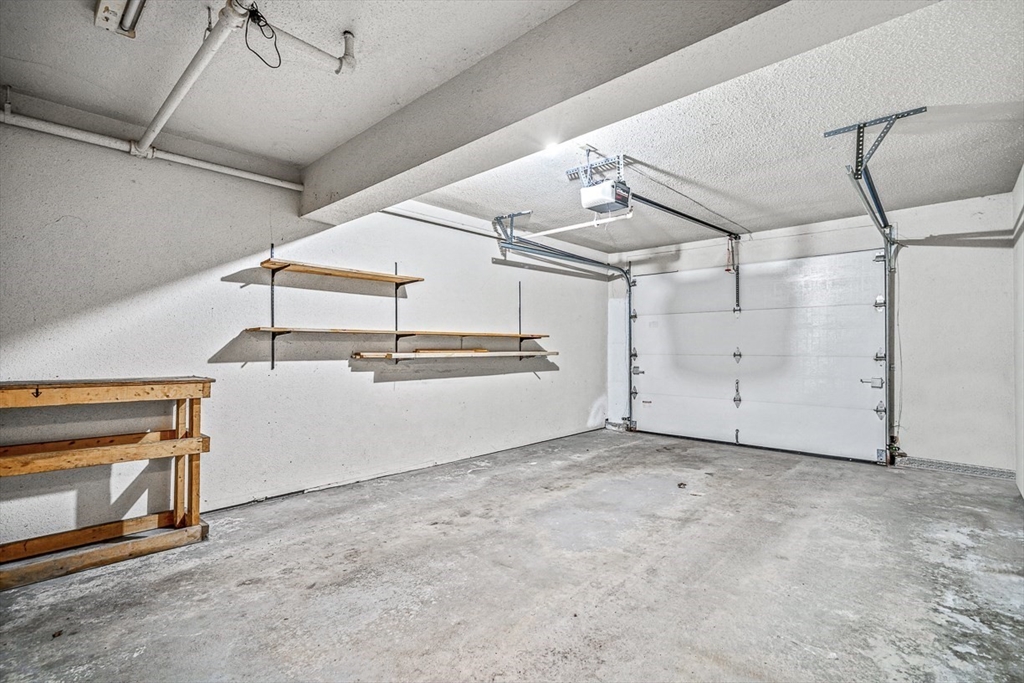 124 Tennis Plaza Road, Unit 21 Dracut, MA 01826 - Photo 21 of 27 a view of a garage