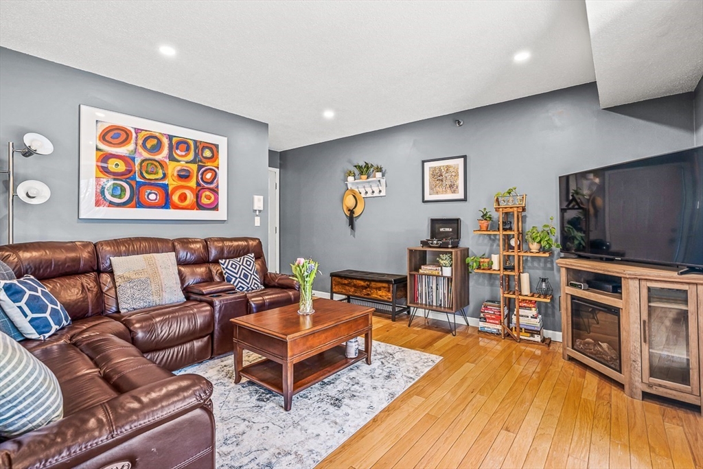 124 Tennis Plaza Road, Unit 21 Dracut, MA 01826 - Photo 4 of 27 a living room with furniture and a flat screen tv