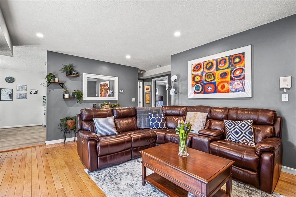124 Tennis Plaza Road, Unit 21 Dracut, MA 01826 - Photo 5 of 27 a living room with furniture and wooden floor