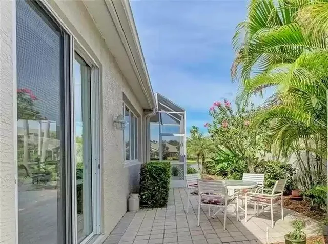 a view of balcony with couple of potted plants