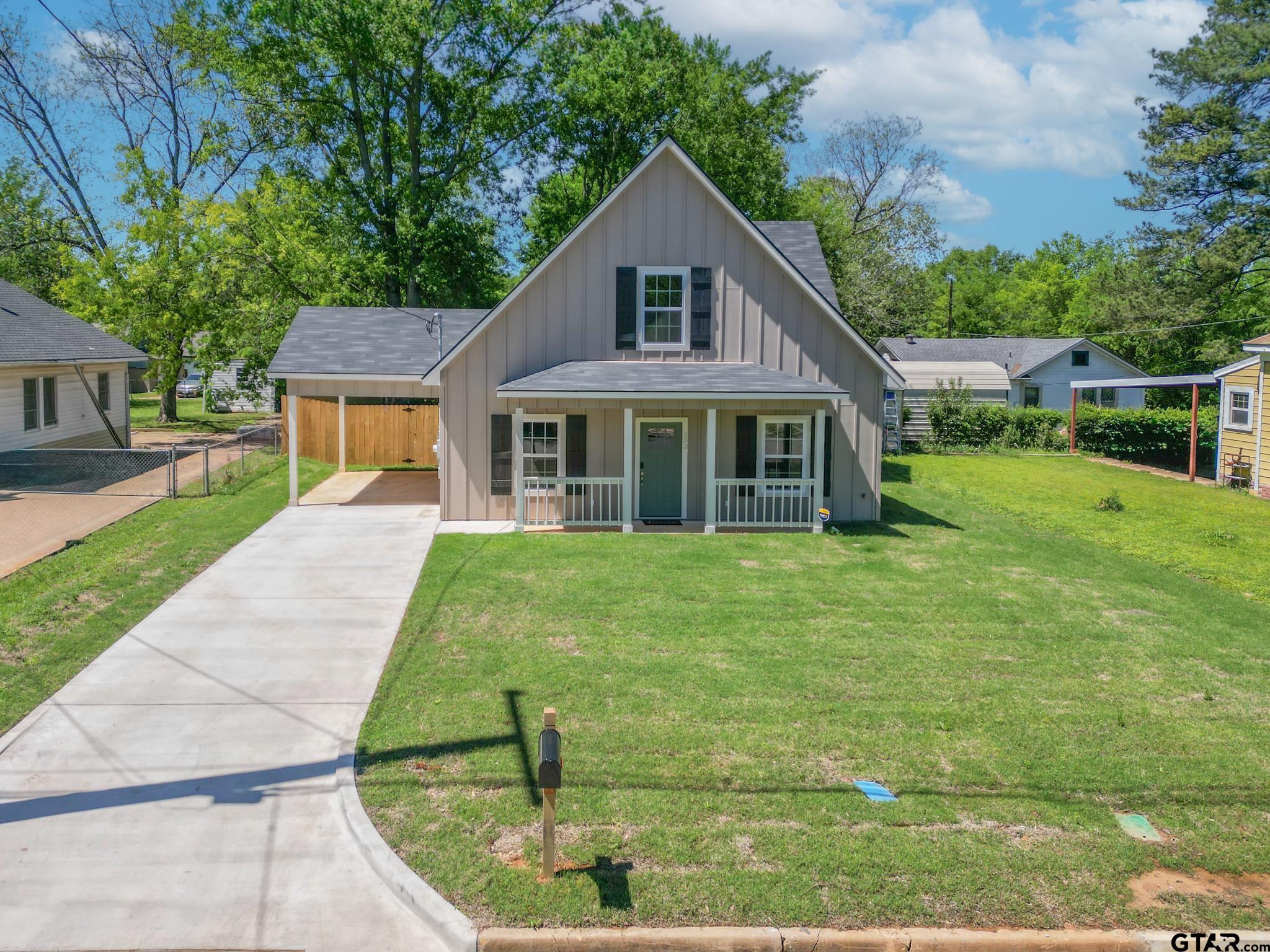 233 Harrison Street Longview, TX 75601 - Photo 1 of 44 a front view of a house with a yard