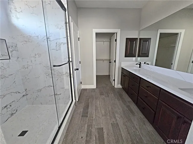 a bathroom with a double vanity sink and mirror with bathtub
