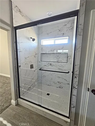 a bathroom with a glass shower door