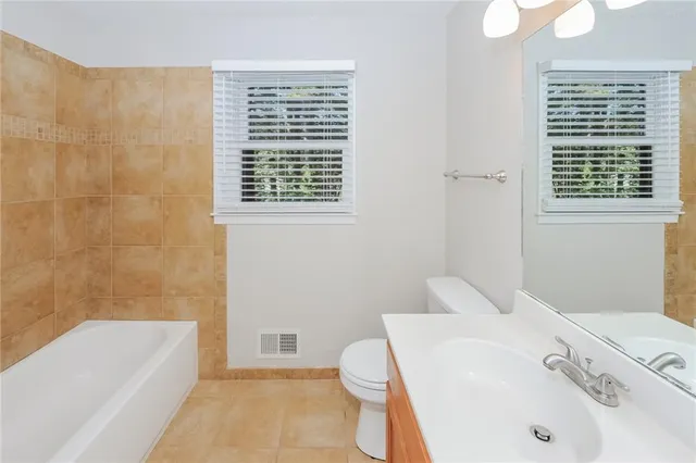 a bathroom with a sink a toilet and bathtub