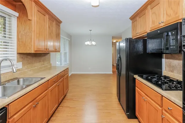 a kitchen with stainless steel appliances a sink stove and refrigerator