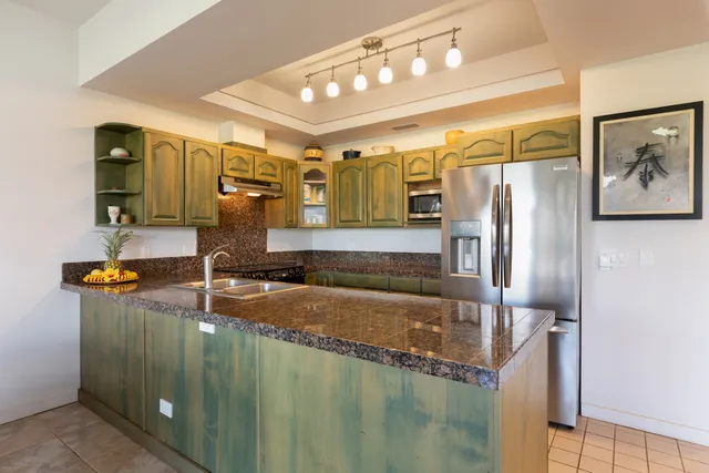 a bathroom with a granite countertop sink and a large mirror