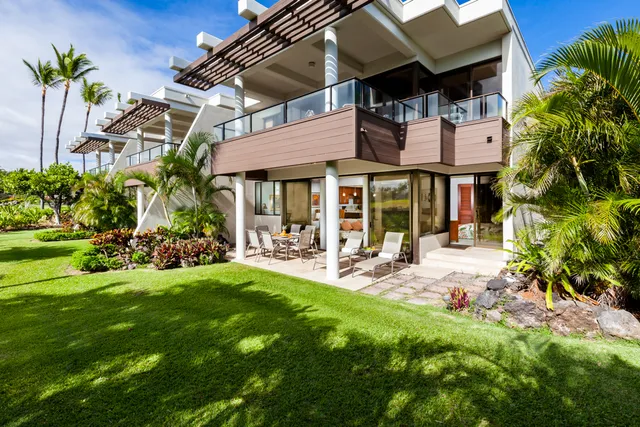 a view of a house with backyard porch and sitting area
