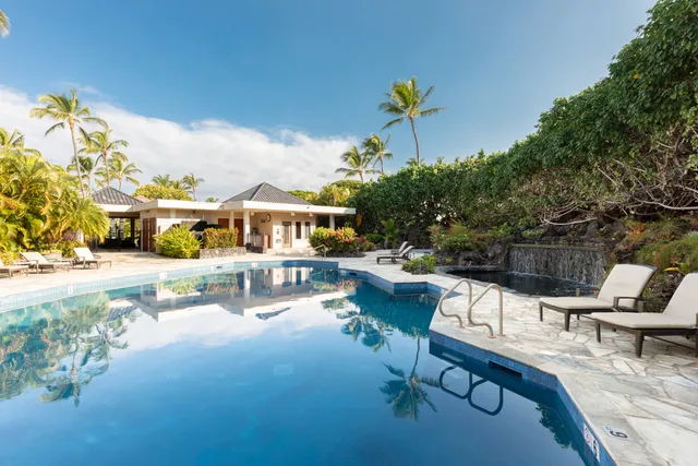 a swimming pool with outdoor seating and yard