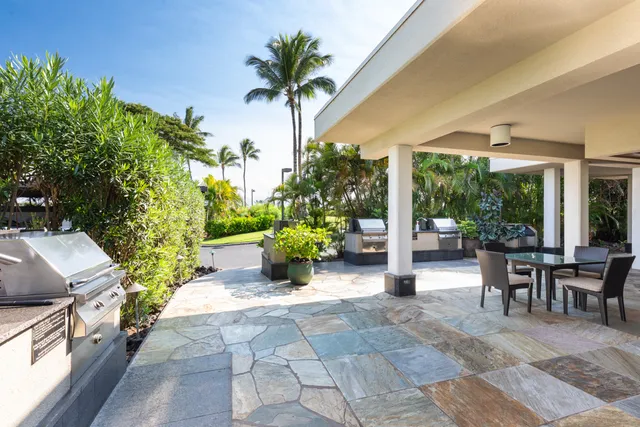 a view of a patio with table and chairs potted plants with palm trees