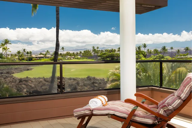 a view of a lake from a balcony with dining table and chairs