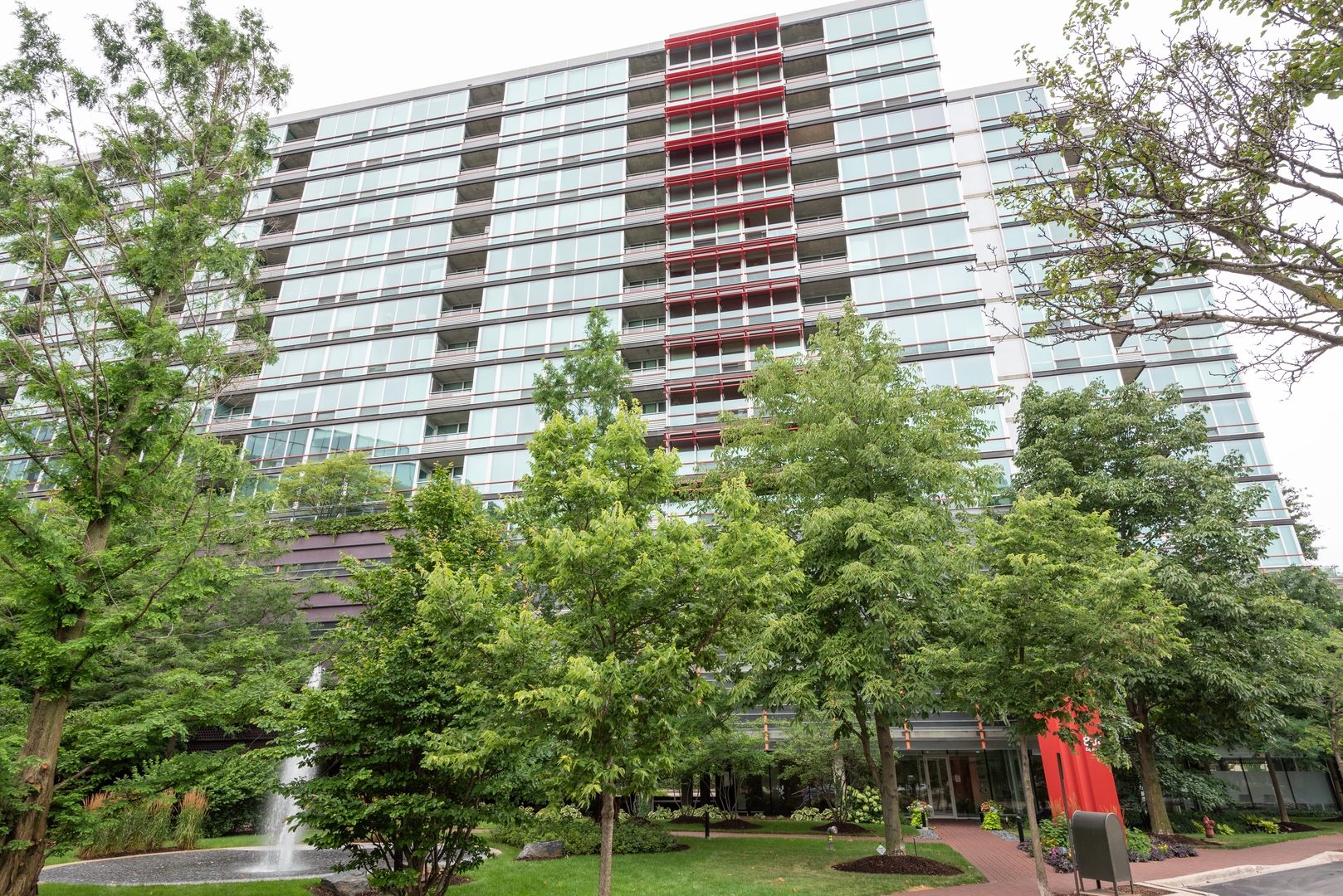 800 Elgin Road, Unit 711 Evanston, IL 60201 - Photo 1 of 18 a view of a building with a garden and pathway