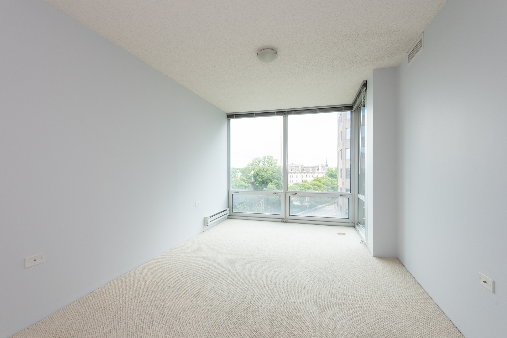 800 Elgin Road, Unit 711 Evanston, IL 60201 - Photo 11 of 18 an empty room with large windows and red door