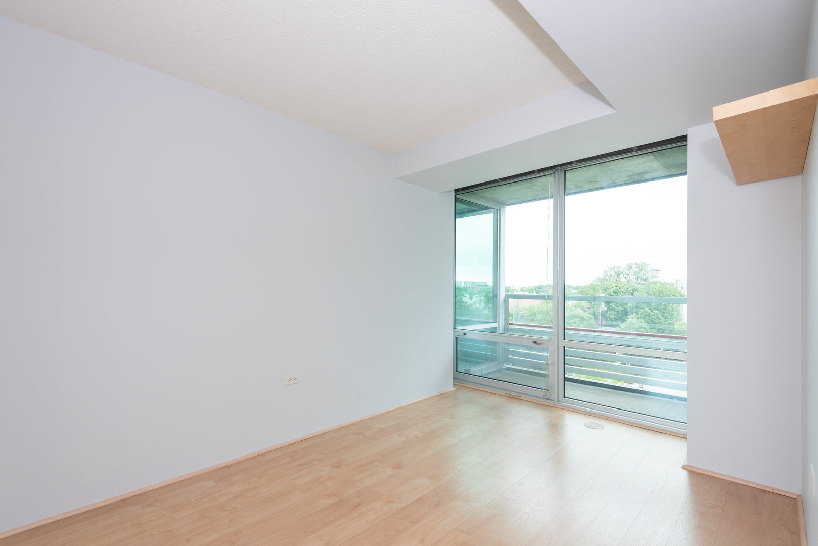 800 Elgin Road, Unit 711 Evanston, IL 60201 - Photo 14 of 18 an empty room with wooden floor and windows