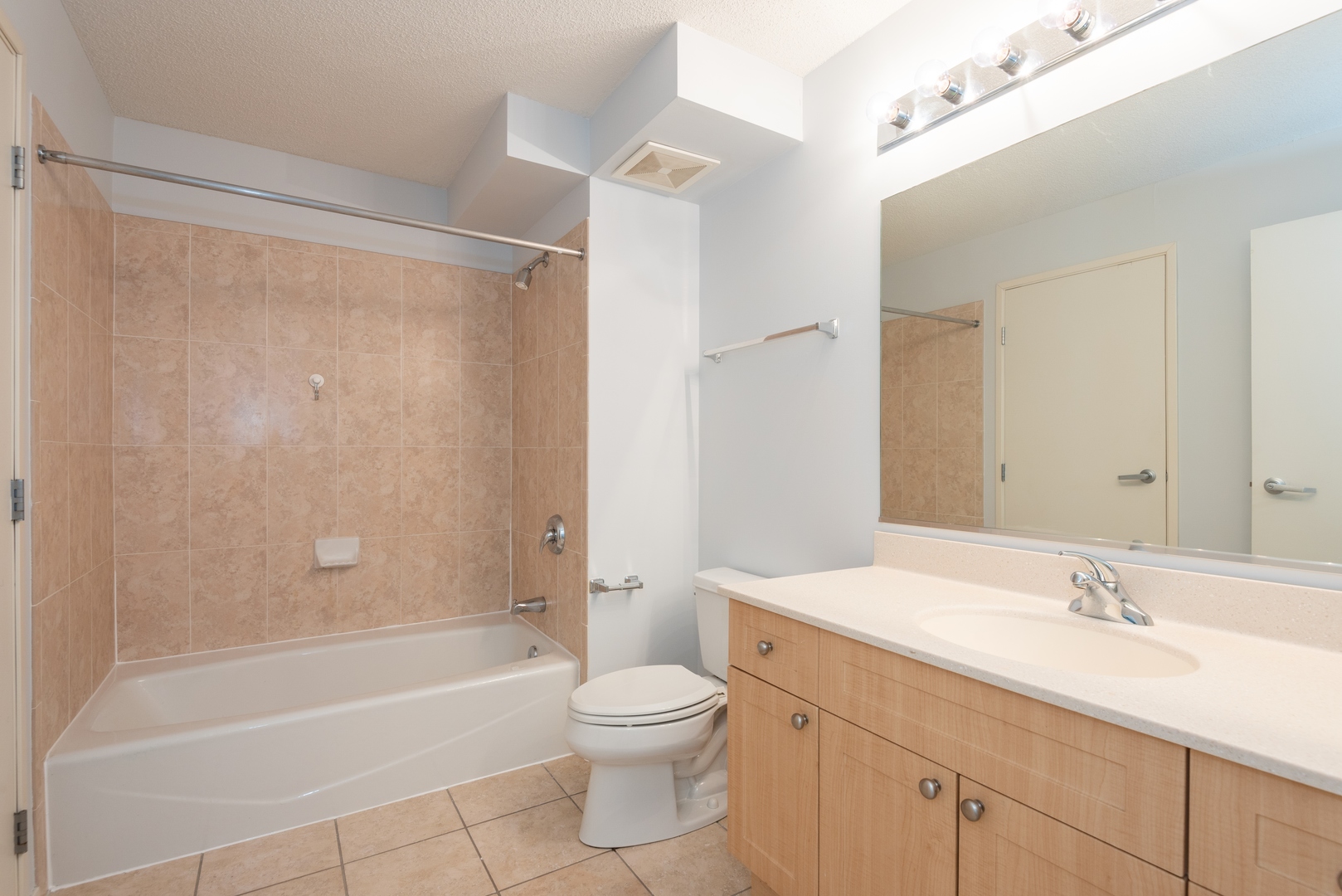 800 Elgin Road, Unit 711 Evanston, IL 60201 - Photo 15 of 18 a bathroom with a granite countertop sink a toilet and shower