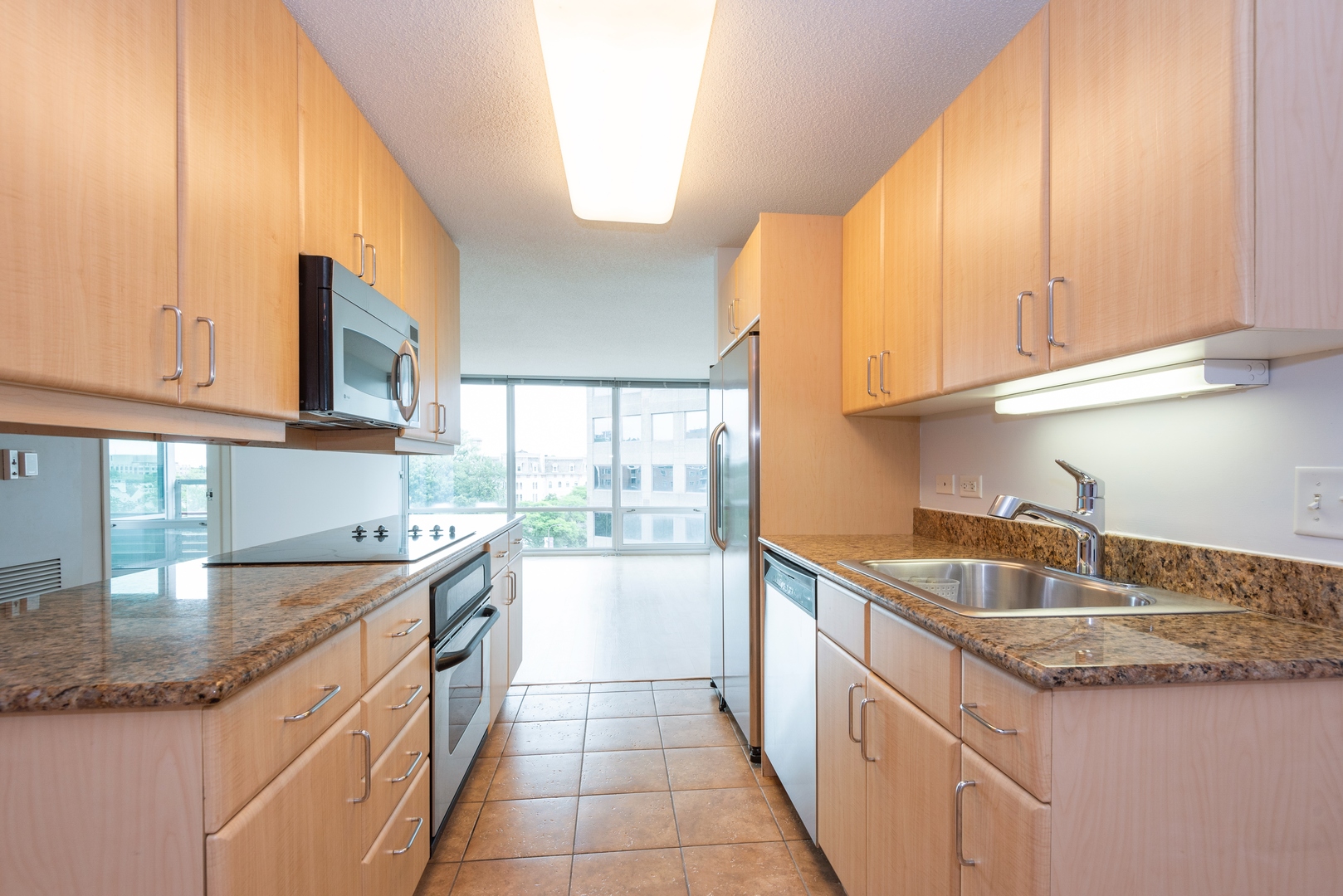 800 Elgin Road, Unit 711 Evanston, IL 60201 - Photo 6 of 18 a kitchen with stainless steel appliances granite countertop a sink and cabinets