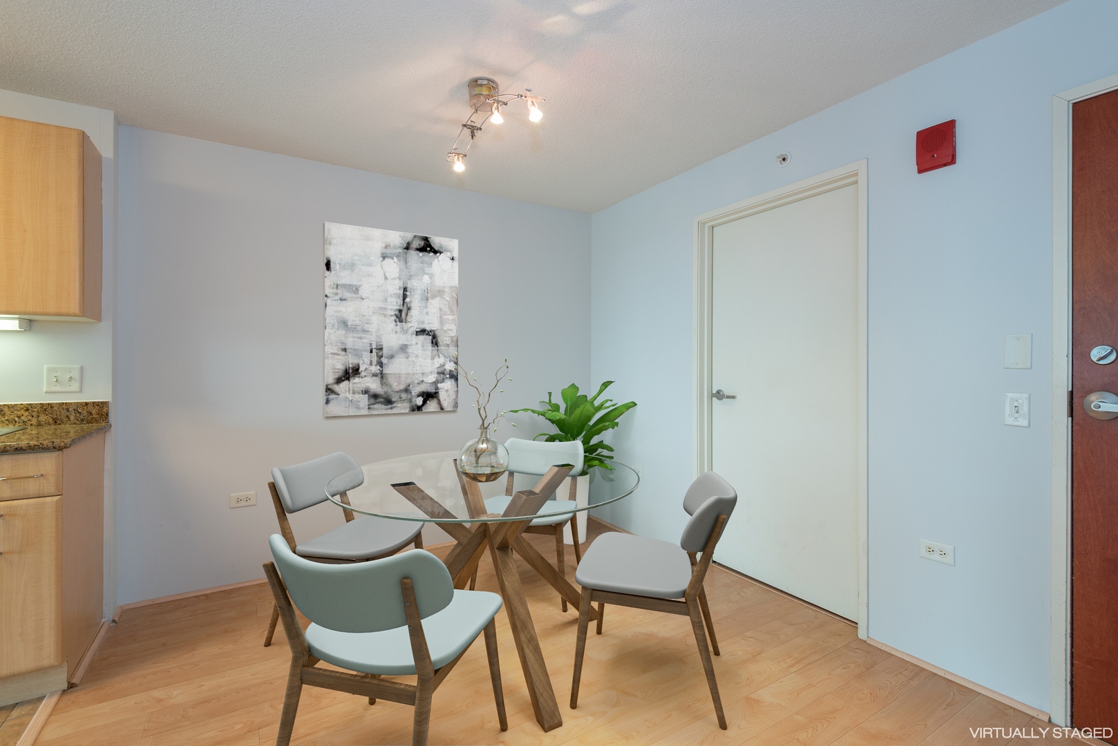 800 Elgin Road, Unit 711 Evanston, IL 60201 - Photo 8 of 18 a view of a dining room with furniture and a potted plant