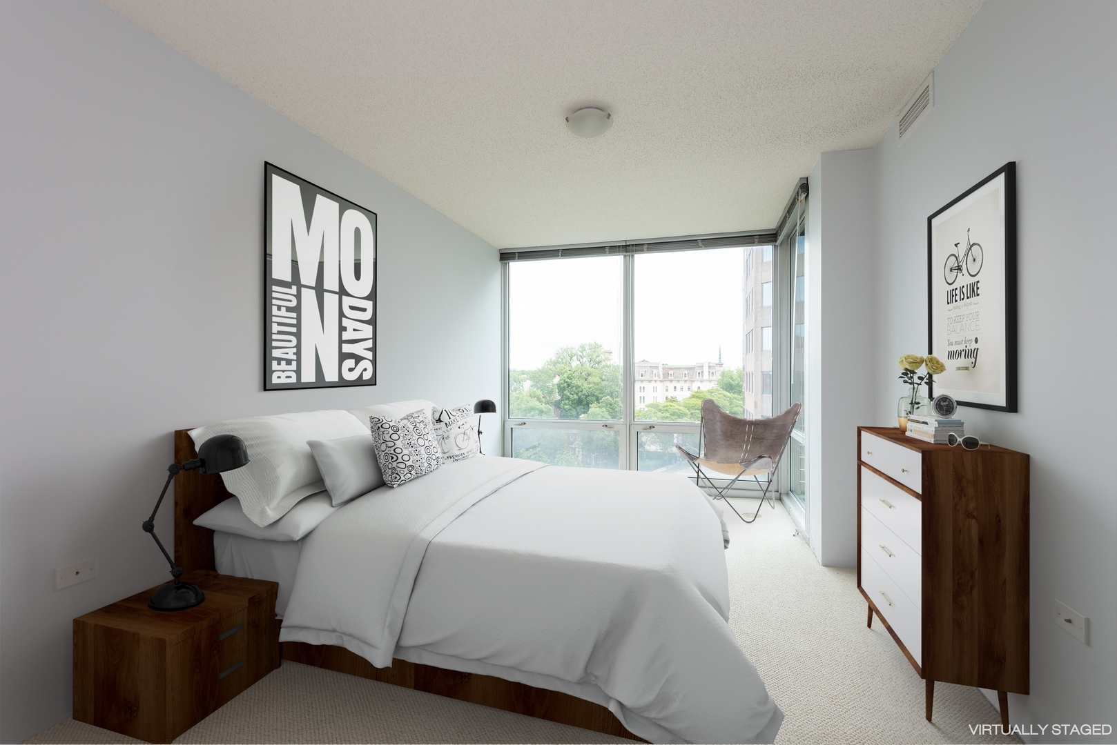 800 Elgin Road, Unit 711 Evanston, IL 60201 - Photo 10 of 18 a bedroom with a bed and a large window