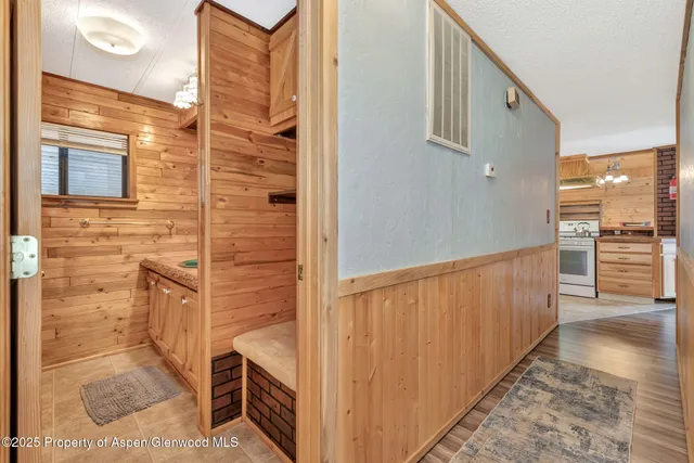 a view of a hallway with wooden cabinets
