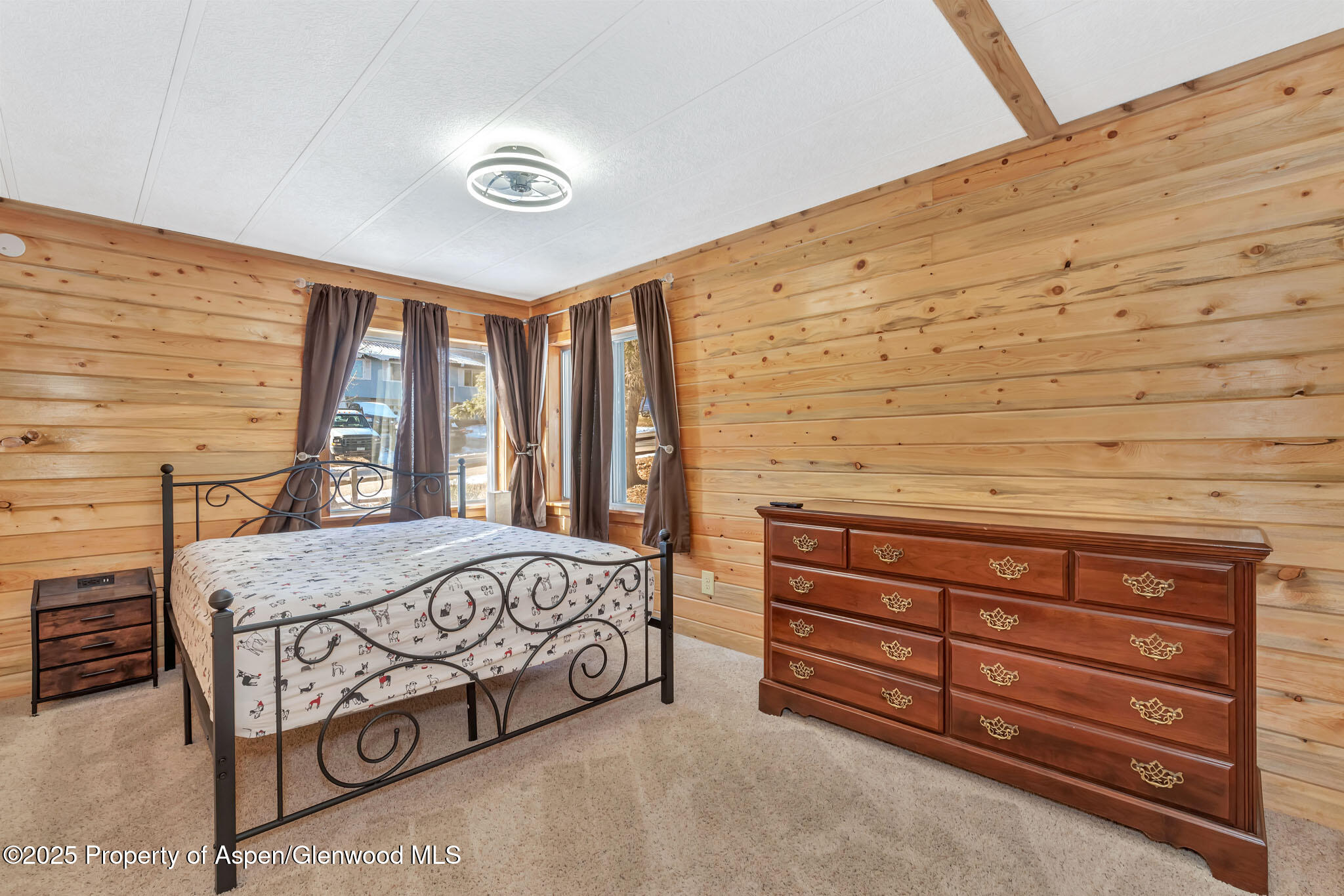 759 Ashley Road Craig, CO 81625 - Photo 20 of 44 a bedroom with a bed and a dresser next to a window