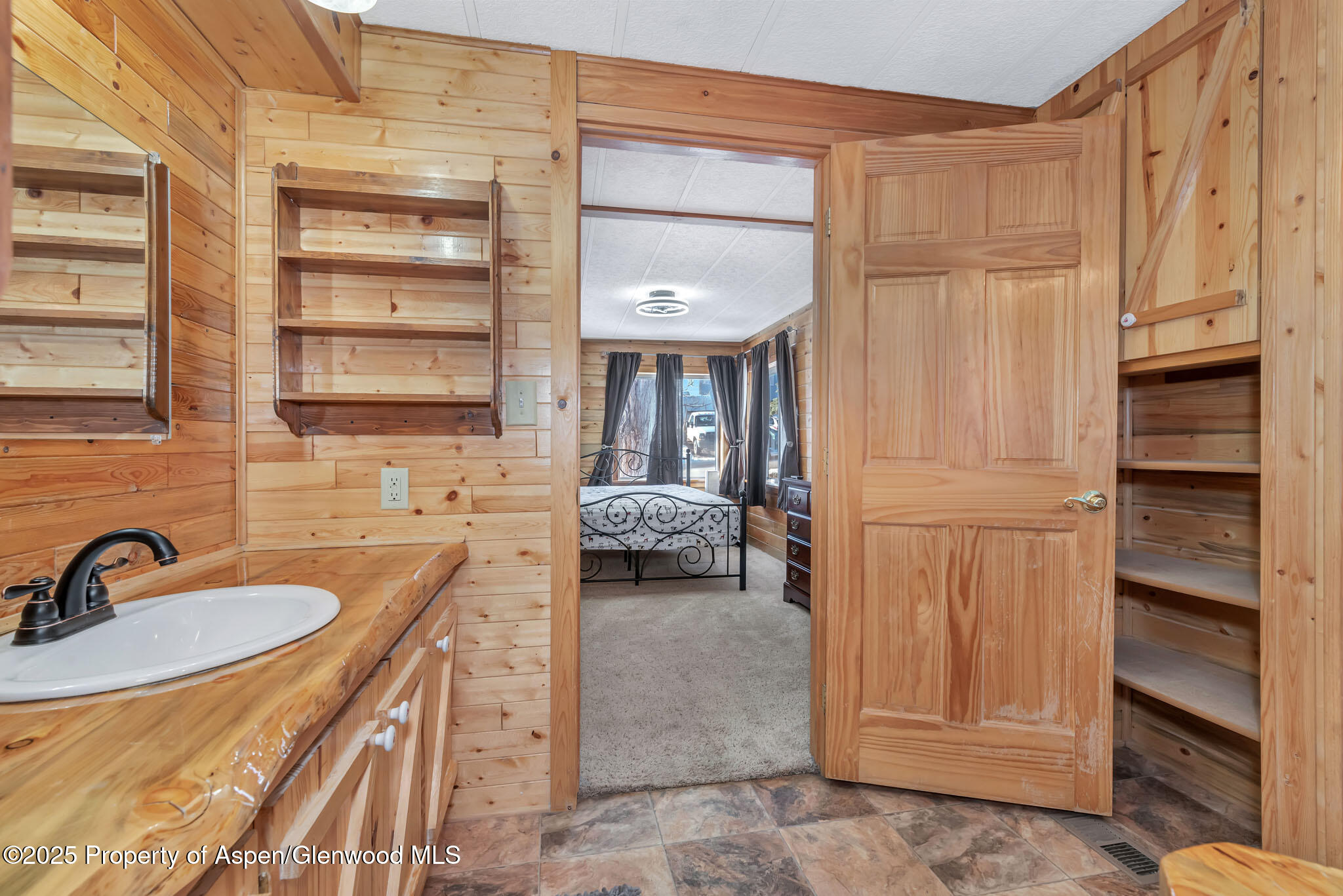 759 Ashley Road Craig, CO 81625 - Photo 24 of 44 a en suite bathroom with a sink and a mirror