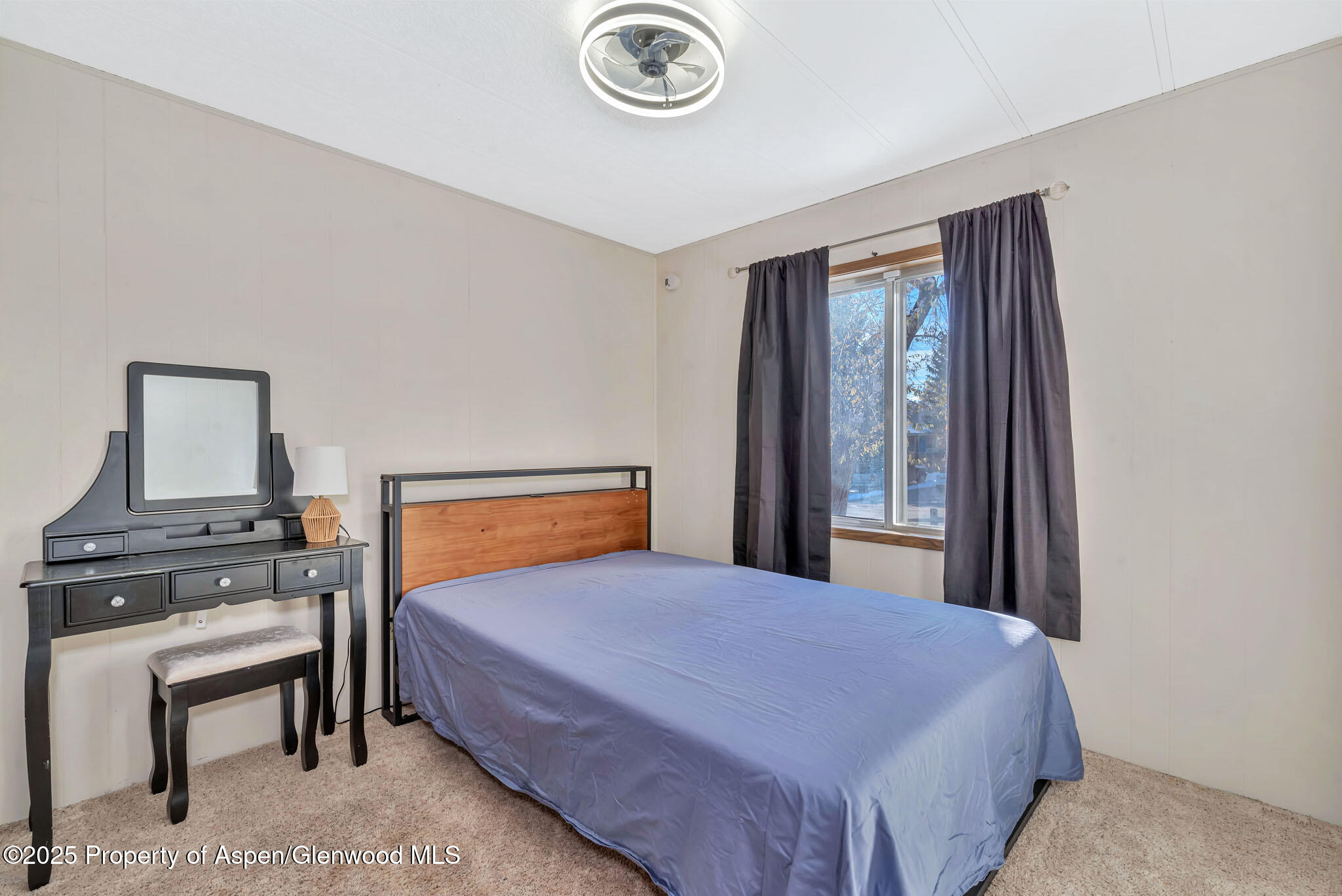 759 Ashley Road Craig, CO 81625 - Photo 25 of 44 a bedroom with a bed and a table