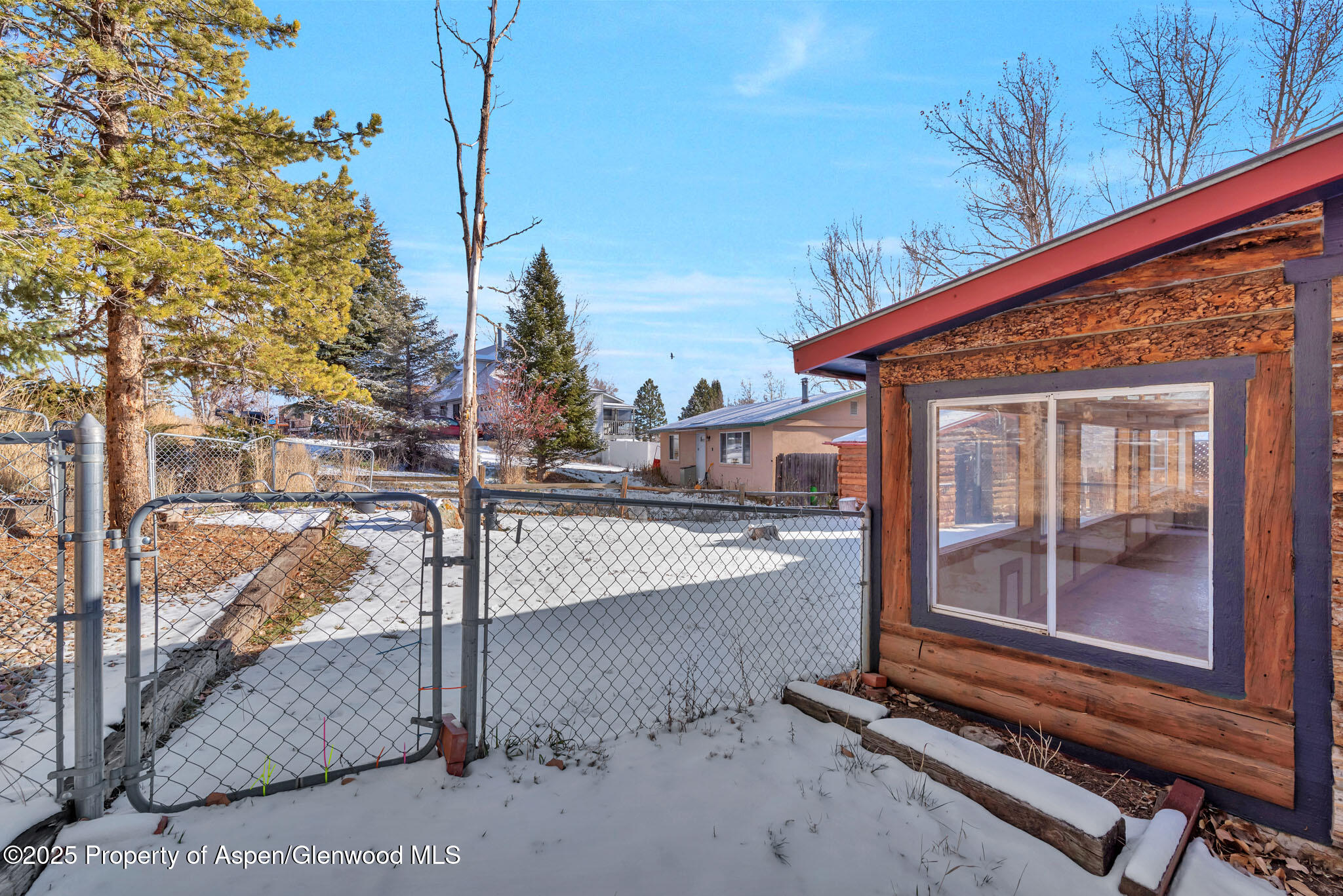 759 Ashley Road Craig, CO 81625 - Photo 38 of 44 a view of a house with a floor to ceiling window and wooden fence