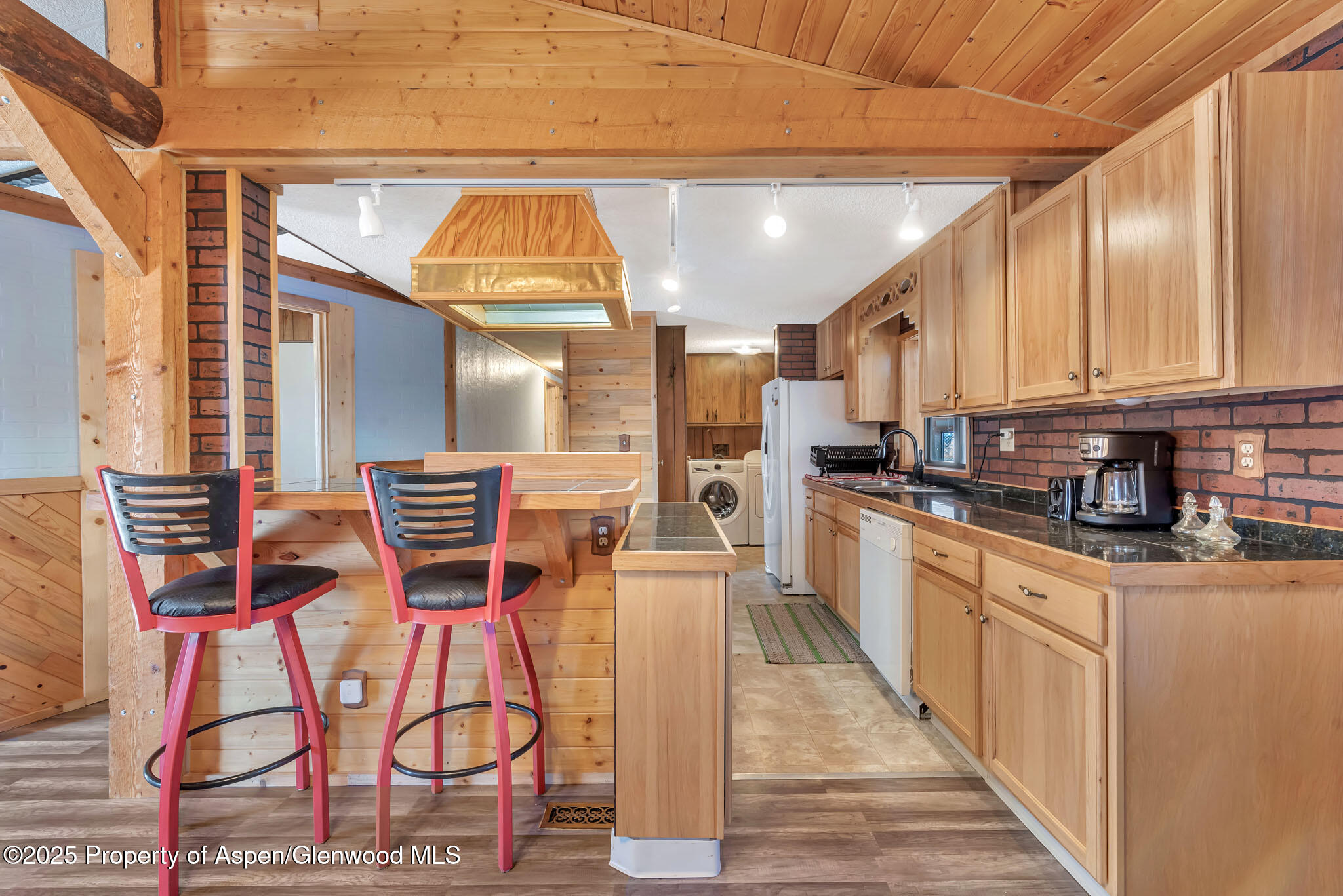 759 Ashley Road Craig, CO 81625 - Photo 10 of 44 a kitchen with stainless steel appliances kitchen island granite countertop a refrigerator and microwave