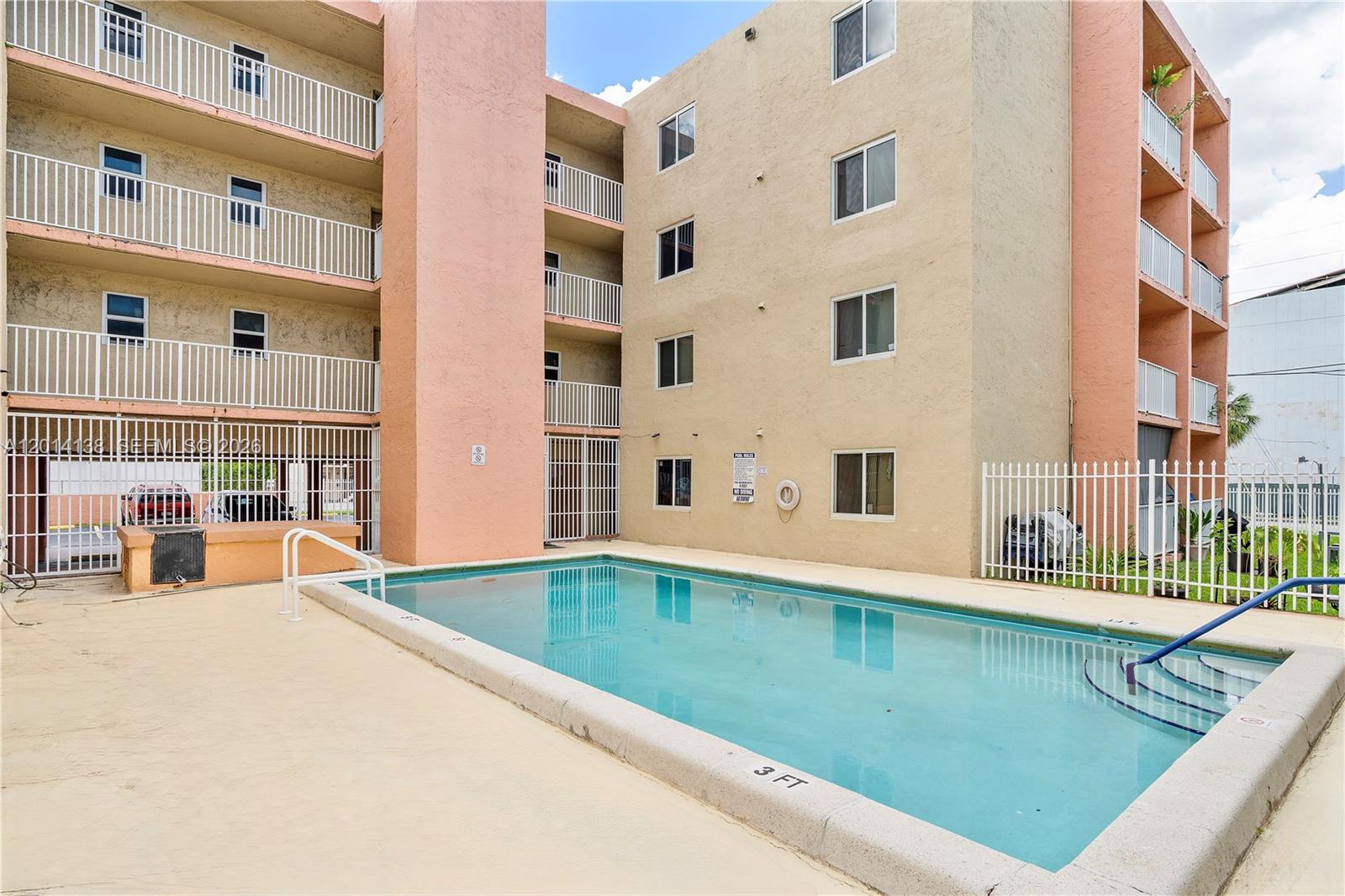 2400 Northwest 16th St Road Miami, FL 33125 - Photo 26 of 47 a view of a swimming pool with a balcony