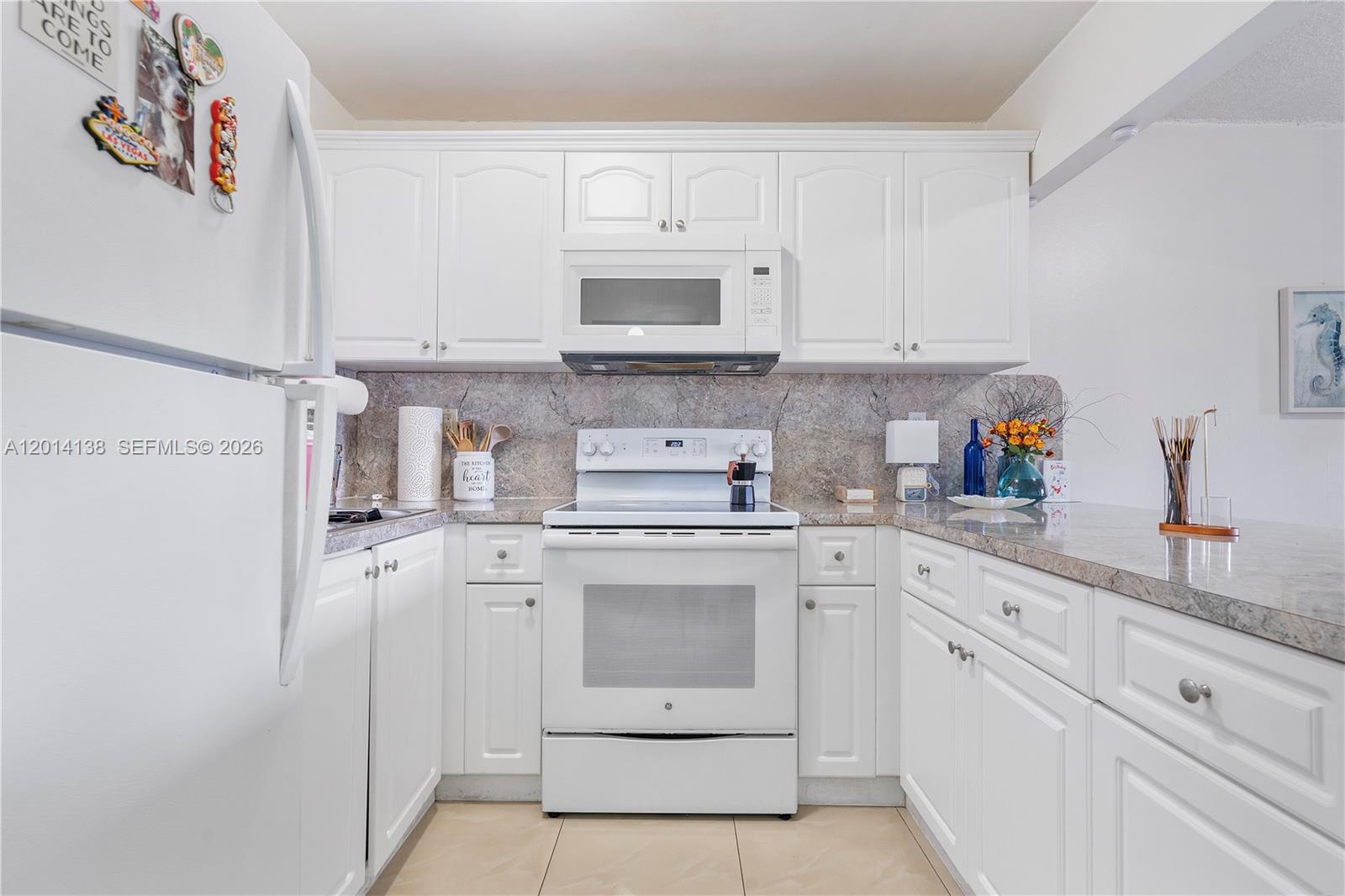 2400 Northwest 16th St Road Miami, FL 33125 - Photo 34 of 47 a kitchen with white cabinets and white appliances