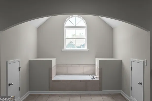 a bathroom with a bathtub and a window
