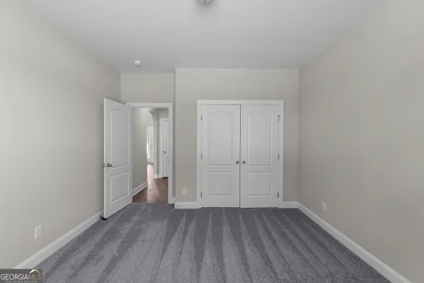 a view of an empty room and closet area