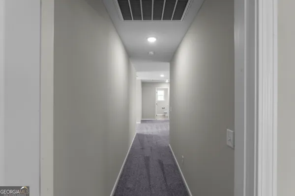a view of hallway with wooden floor